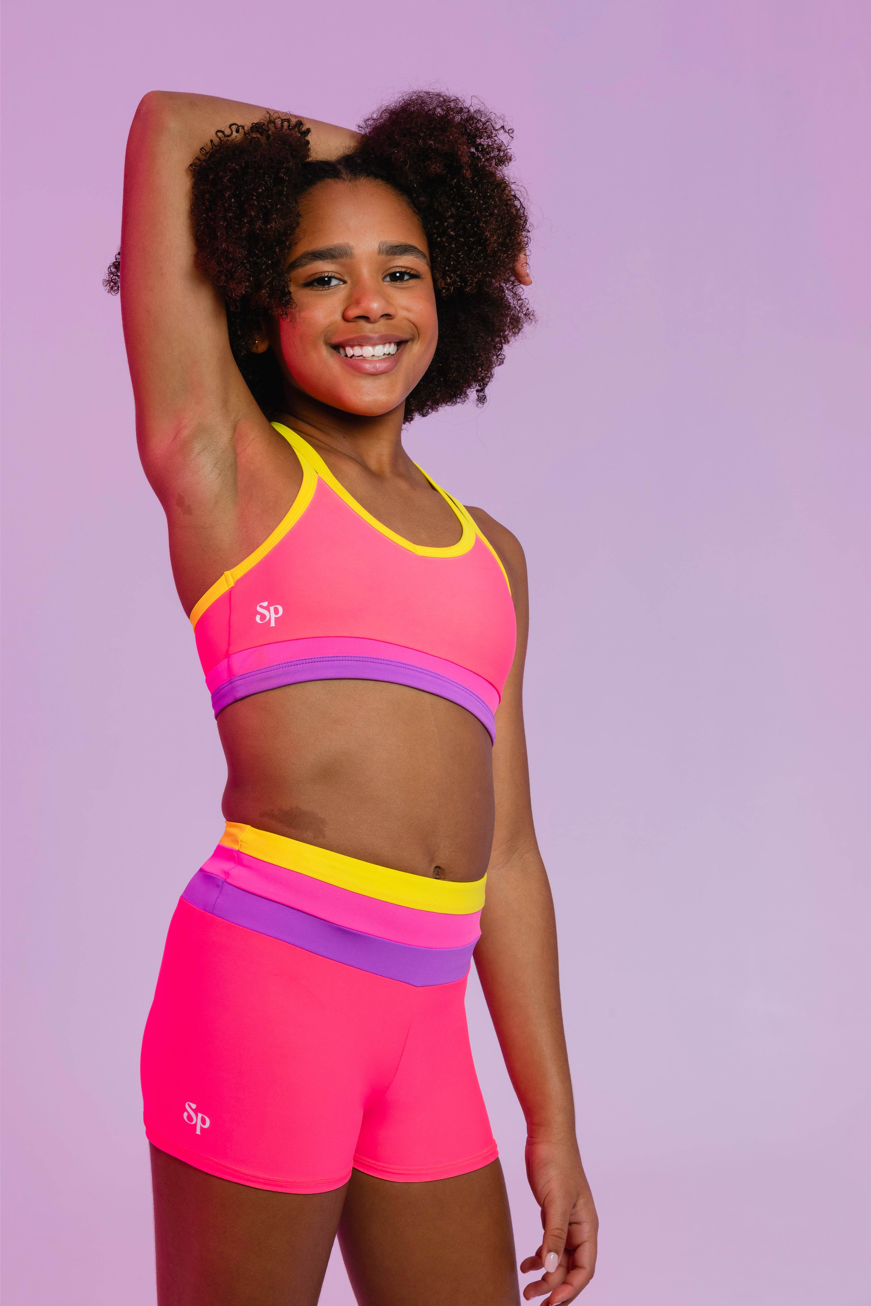 Sylvia P Sugar Gymnastics Crop Top In Pink, Scoop Neckline and Criss Cross Straps, Side View.